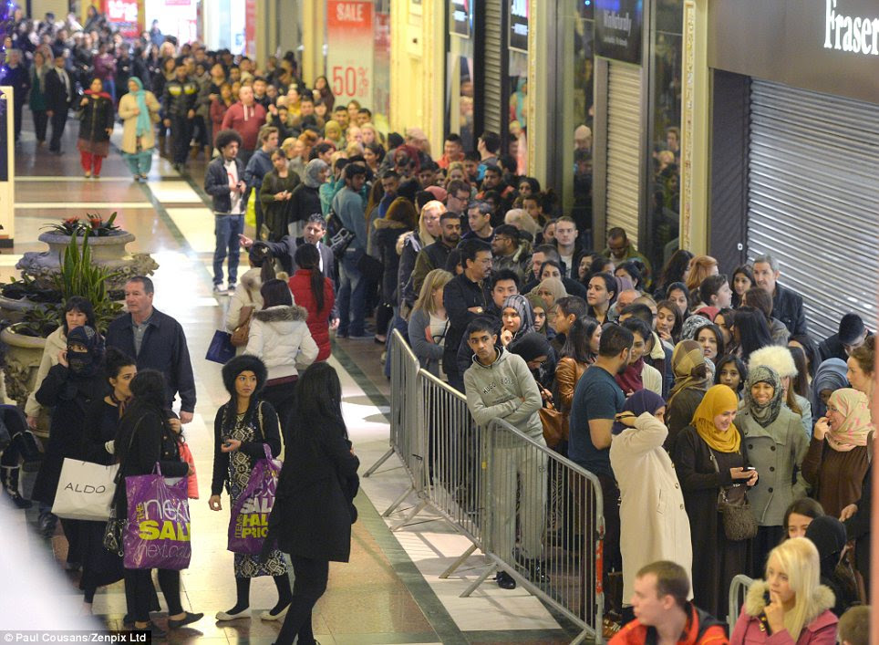 Crush: Shoppers queue up inside Manchester's Trafford Centre to try and get in to Selfridges
