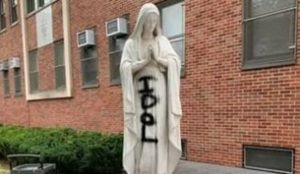 New York City: “IDOL” painted on 100-year-old statue of Virgin Mary