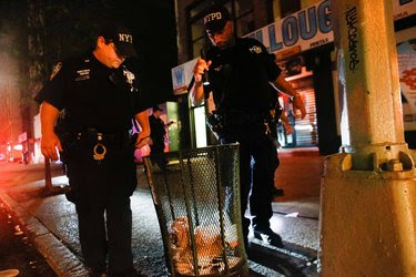 After the explosion in Manhattan on Saturday, members of the New York City Strategic Response Group checking trash bins along Fifth Avenue.