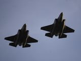 In this Nov. 1, 2018, file photo U.S. Air Force F-35 A-fighter jets from 31st Test Evaluation Squadron at Edwards AFB fly over Levi&#39;s Stadium before an NFL football game between the San Francisco 49ers and the Oakland Raiders in Santa Clara, Calif. Raytheon Co. and United Technologies Corp. are merging in a deal that creates one of the world&#39;s largest defense companies. The merger was announced Sunday, June 9, 2019. United Technologies makes engines for Lockheed Marti Corp.&#39;s F-35 stealth fighter. (AP Photo/Ben Margot, File)