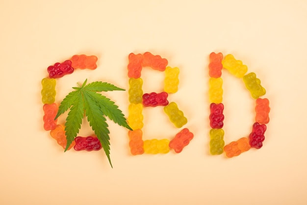 Colored cbd candy jelly and cannabis green leaf lettering