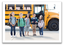 Photo of kids in front of a bus