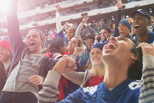 Fans cheering at American football game