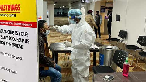 An passenger gives sample for COVID-19 test at the IGI airport, New Delhi. (TOI, BCCL-DELHI)
