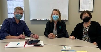 Photo of three people sitting at a table