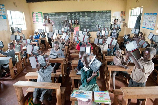 Kenya-Classroom-holding-up-ereaders-World-Reader.jpg
