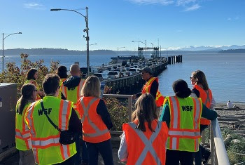 Several people in safety vests gathered at Fauntleroy dock