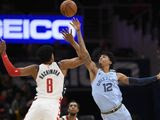 Memphis Grizzlies guard Ja Morant (12) and Washington Wizards forward Rui Hachimura (8) battle for the ball during the first half of an NBA basketball game, Sunday, Feb. 9, 2020, in Washington. (AP Photo/Nick Wass)