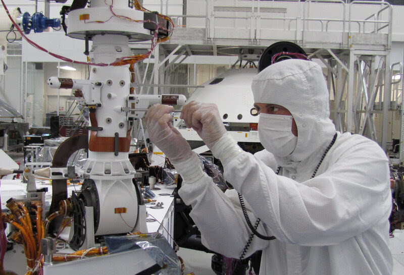 Installing one of the two mini-booms on the rover Curiosity that will monitor weather conditions on Mars, NASA's Jet Propulsion Laboratory, 2010.