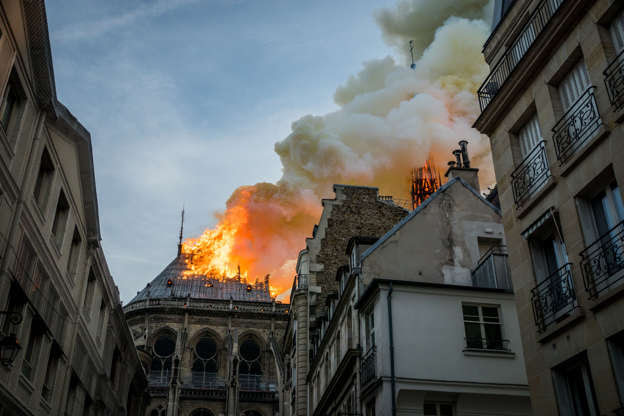 Slide 16 of 31: Smokes and flames rise during a fire at Notre-Dame Cathedral in central Paris, France, on April 15, 2019.- A fire broke out at the landmark Notre-Dame Cathedral in central Paris, potentially involving renovation works being carried out at the site, the fire service said. (Photo by Nicolas Liponne/NurPhoto via Getty Images)