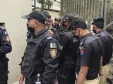 In this image made from a video, police stand around an entrance of stock exchange building in Karachi, Pakistan Monday, June 29, 2020. Militants attacked the stock exchange in the Pakistani city of Karachi on Monday, according to police. (AP Photo)