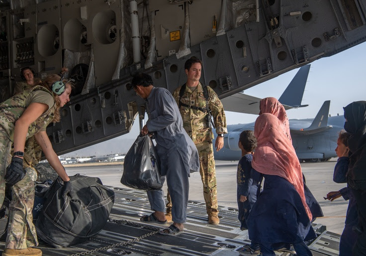 Refugees boarding a military plan in Kabul