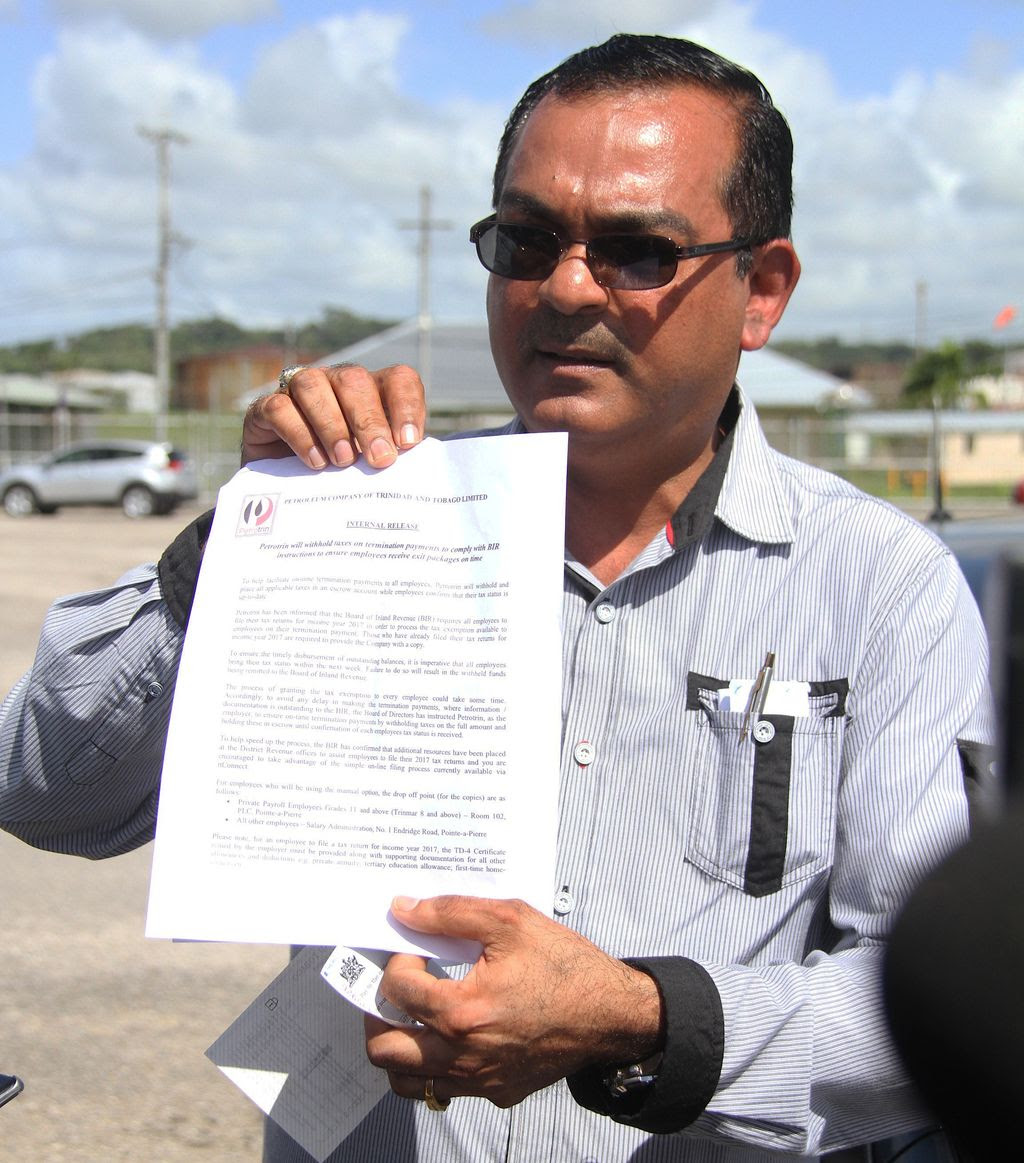 Former Petrotrin employee Shankar Teelucksingh shows the media a copy of a Petrotrin document relating to taxes during an interview at Guaracara Park, Pointe-a-Pierre, yesterday.