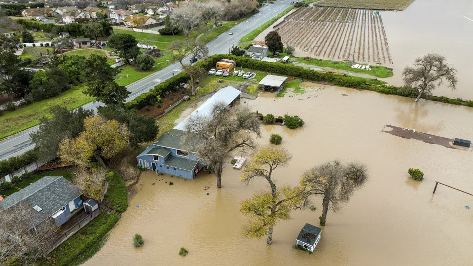 Floodwater covers a property along River Rd. in Monterey County, Calif., as the Salinas River overflows its banks on Friday, Jan. 13, 2023. (AP Photo/Noah Berger)
