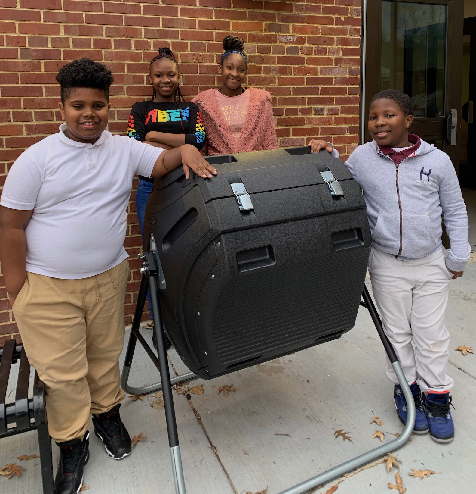 C. W. Harris students standing with a compost bin purchased with EcoRise Eco-Audit Grant funds.