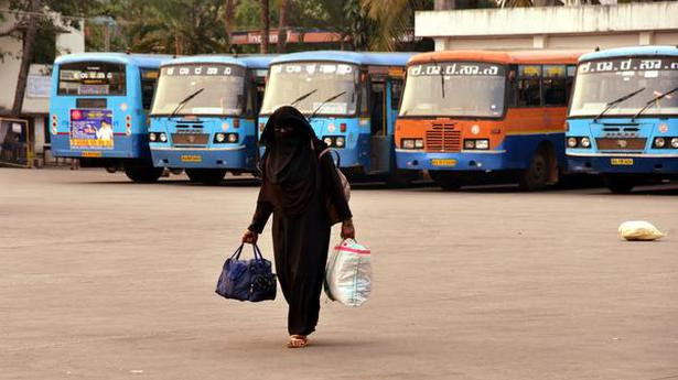  A lady walking with luggages inside a KSRTC bus stand at Bejai during Road Transport Corporation (RTC) employees’ indefinite strike, in Mangaluru on April 7, 2021. 