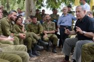 Prime Minister Benjamin Netanyahu meets with IDF soldiers as he tours the southern Israeli border with Gaza.