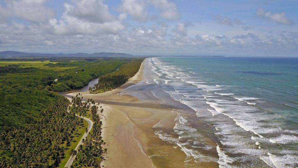 This aerial view along Trinidad’s east coast highlights the intrinsic linkages of watershed environments and the coastal zone. The hydrologic connections between upstream and downstream areas creates finely balanced ecosystems. The intersection of road networks, watersheds and coastal zones is a common feature of island life.