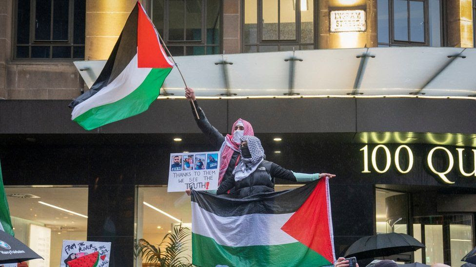 Protestors waving Palestinian flags