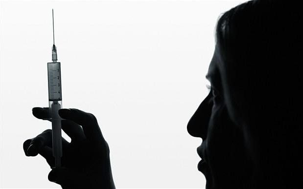A woman holds a needle