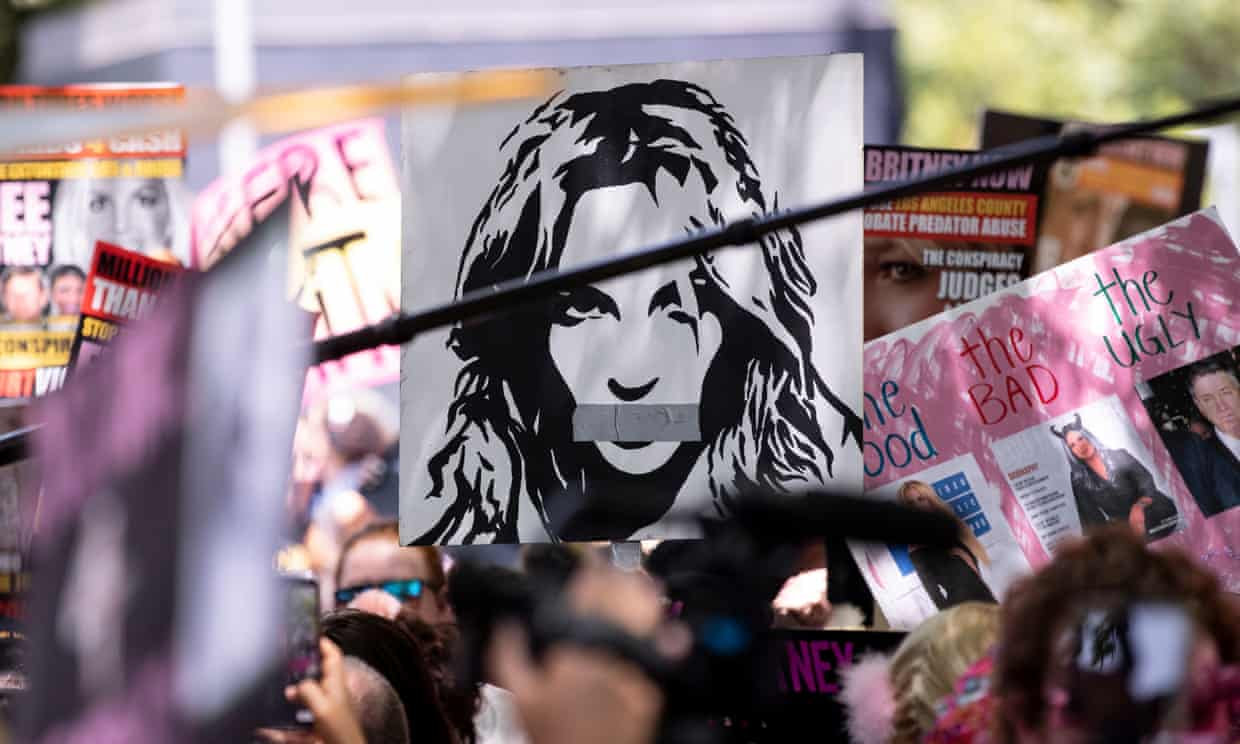 A protest with a sign with Britney Spears with her mouth taped
closed