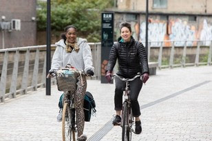 Two women cycle in London