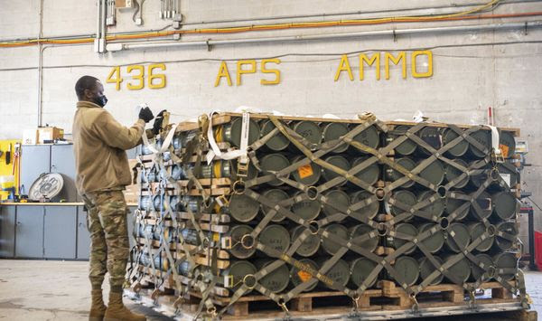 In this image provided by the U.S. Air Force, airmen and civilians from the 436th Aerial Port Squadron palletize ammunition, weapons and other equipment bound for Ukraine during a foreign military sales mission at Dover Air Force Base, Del., Jan. 21, 2022. (Mauricio Campino/U.S. Air Force via AP)