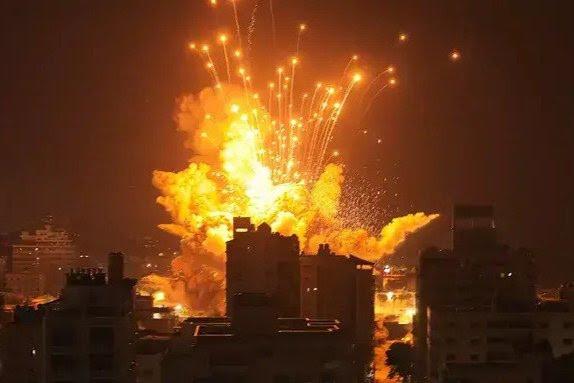 A missile explodes in Gaza City during an Israeli air strike.