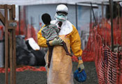 Photo by John Moore/Getty Images, Health worker in personal protective equipment carries a child suspected of having Ebola in treatment center