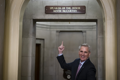 House Speaker Kevin McCarthy of Calif., gestures towards the newly installed nameplate at his office after he was sworn in as speaker of the 118th Congress in Washington, early Saturday, Jan. 7, 2023. 