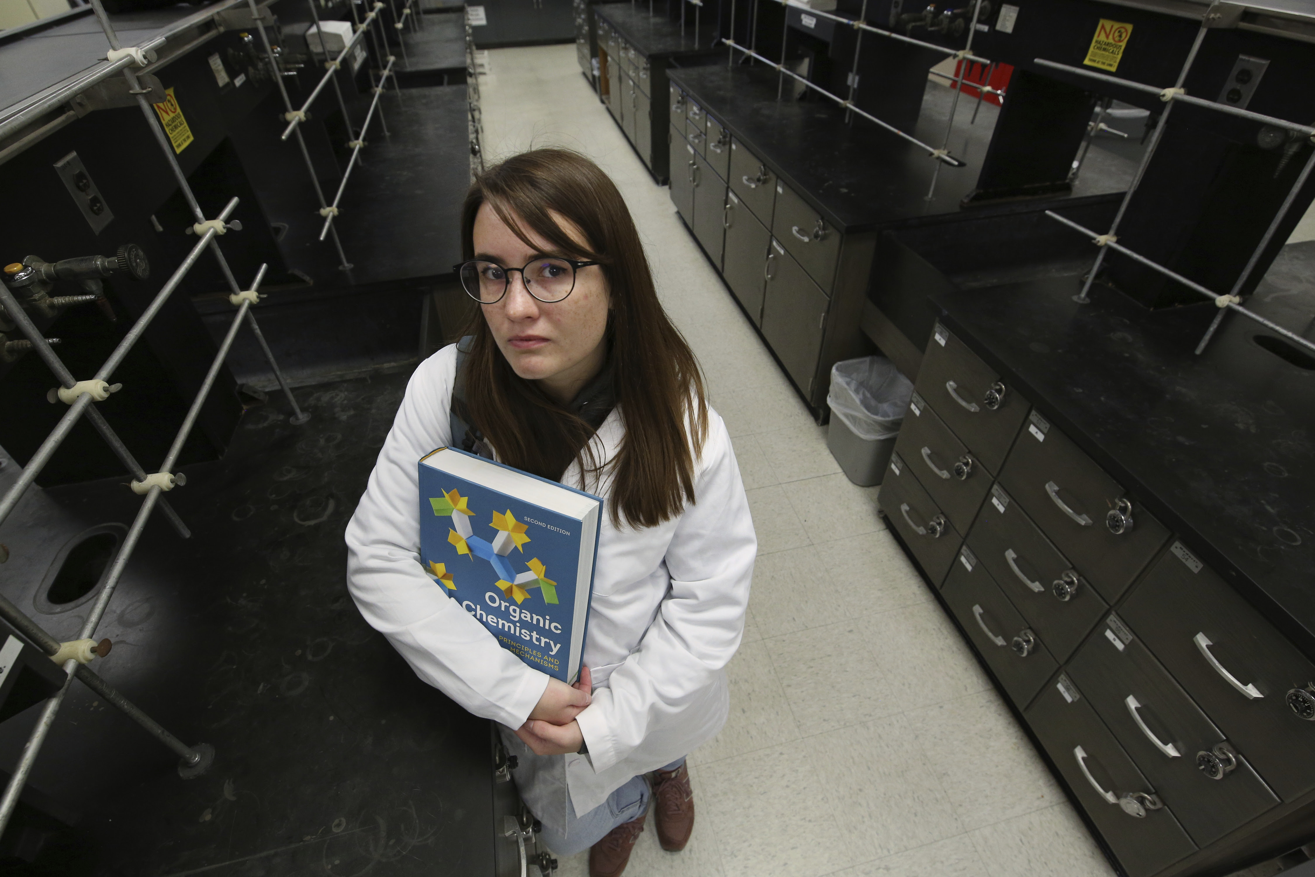 Ricki Korba, 23, stands for a portrait in her lab at California State University, Bakersfield in Bakersfield, Calif., on Friday, April 14, 2023.