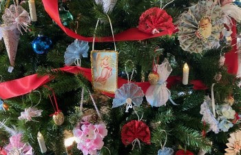 Vintage-style ornaments, lights and ribbon decorate a holiday tree. 
