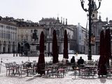 Few people sit at tables outside a bar in the center of Turin, Northern Italy, Sunday, March 8, 2020. Italy announced a sweeping quarantine early Sunday for its northern regions, igniting travel chaos as it restricted the movements of a quarter of its population in a bid to halt the new coronavirus&#39; relentless march across Europe. (Marco Alpozzi/LaPresse via AP)