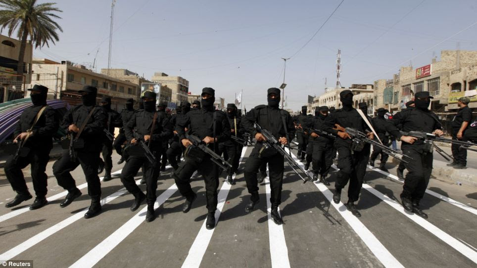 Fighters also marched in support of Shi'ite cleric Moqtada al-Sadr as he rallies troops against the largely Sunni insurgents