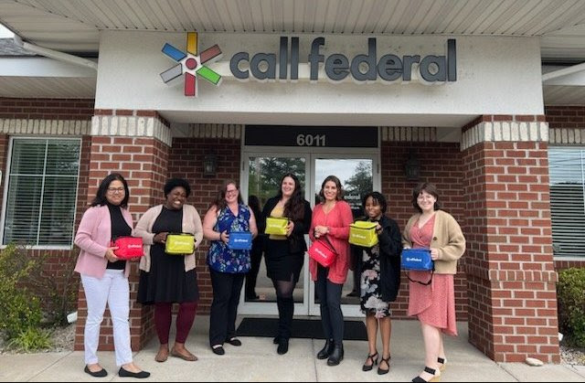 Call Federal Credit Union Team holding lunch coolers