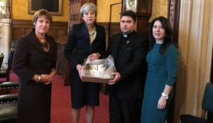 Iraqi Christian leader presents UK Prime Minister Theresa May with Bible burned by the Islamic State