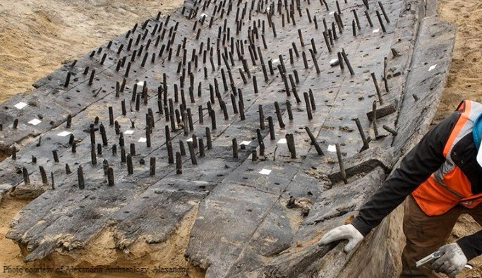 Archaeologist inspects the historic ship. Courtesy of Alexandria Archaeology, Alexandria, Va.