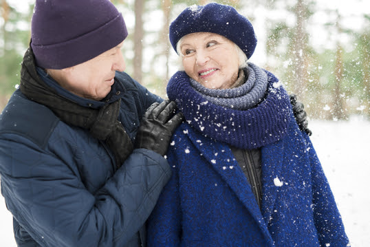 two older adults in the snow