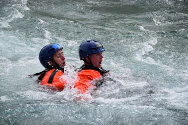 Two Ranger recruits come up for air in the water during training