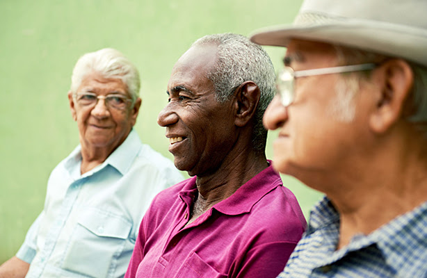 Three senior men sitting together.