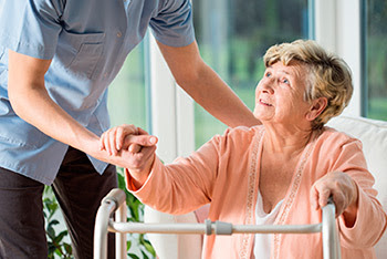 Photo: older woman getting help walking