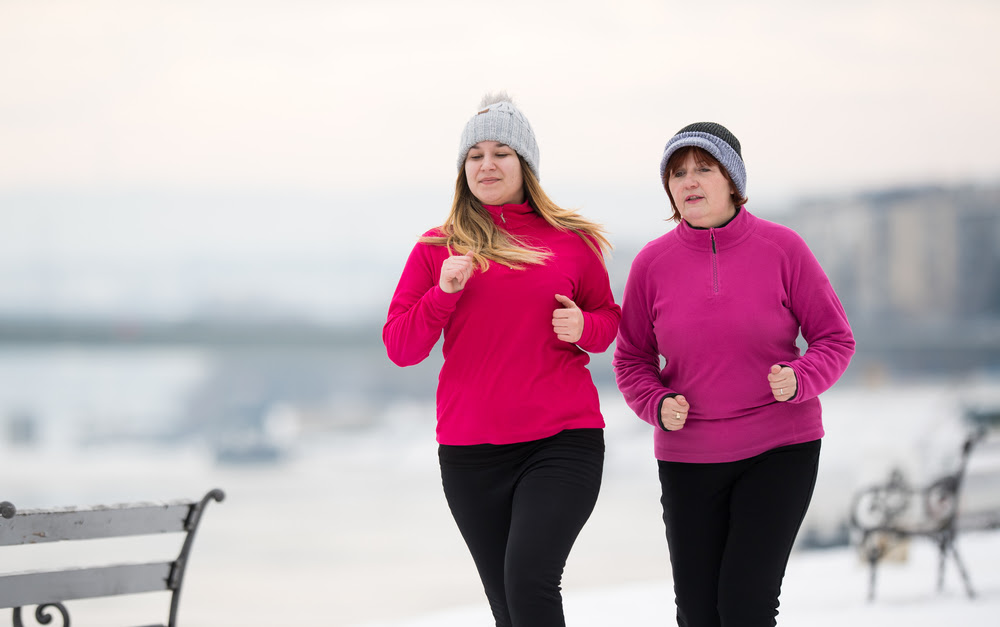 two women jogging in winter weather