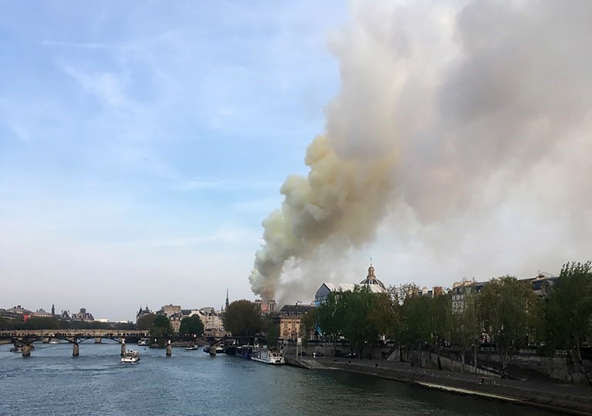 Slide 22 of 31: Flames and smoke are seen billowing from the roof at Notre-Dame Cathedral in Paris on April 15, 2019. - A fire broke out at the landmark Notre-Dame Cathedral in central Paris, potentially involving renovation works being carried out at the site, the fire service said.Images posted on social media showed flames and huge clouds of smoke billowing above the roof of the gothic cathedral, the most visited historic monument in Europe. (Photo by Pierre Galey / AFP) (Photo credit should read PIERRE GALEY/AFP/Getty Images)