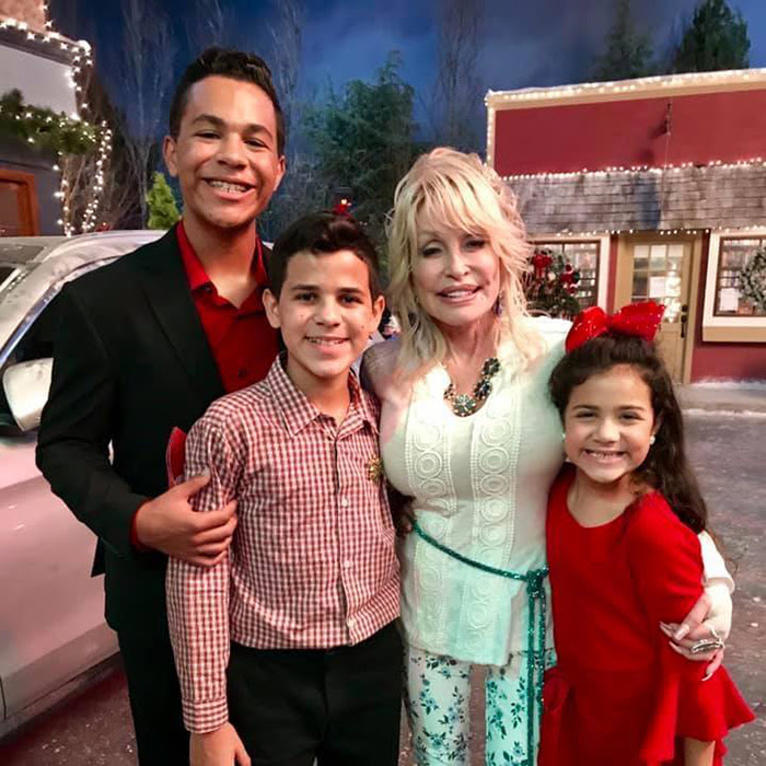 Sixteen-year-old Tristan, 13-year-old Tyson, and 9-year-old Talia with Dolly