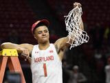 Maryland guard Anthony Cowan Jr. (1) holds up the net after cutting it down after his team won a share of the Big Ten regular season title after defeating Michigan in an NCAA college basketball game, Sunday, March 8, 2020, in College Park, Md. (AP Photo/Nick Wass) ** FILE **