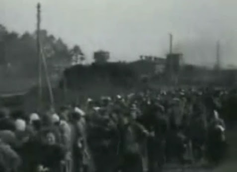 German prisoners of war in a queue                             (11min. 6sec.), many have white bandages on                             their head because of head injuries