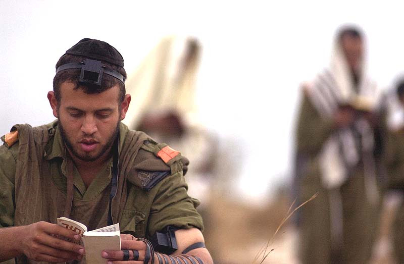 A Nachal soldier partakes in morning prayers before returning to his military activities.