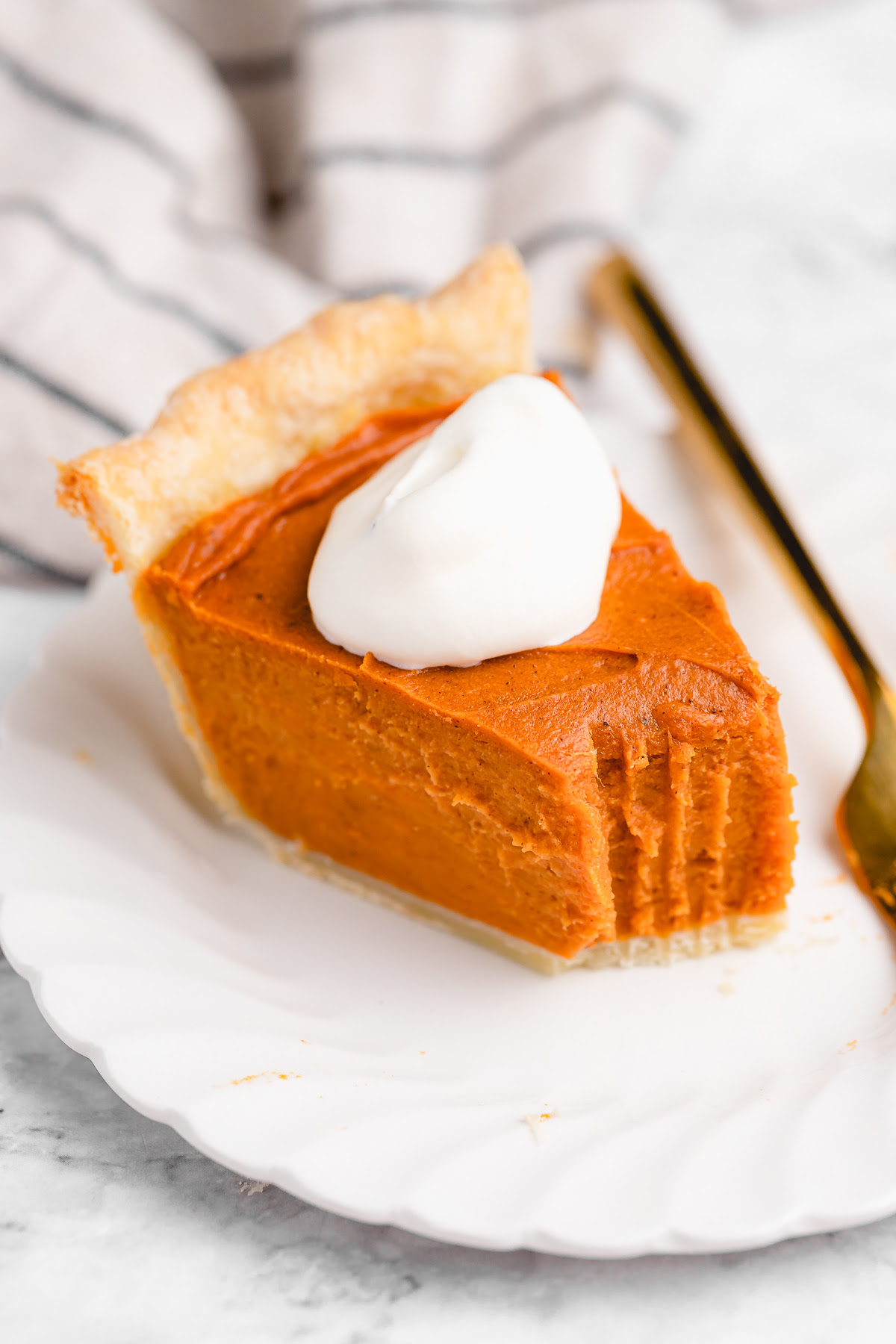 This Vegan Sweet Potato Pie is just like the Southern classic, but made without the dairy and eggs. Sweet, creamy, and perfect! Slice of vegan sweet potato pie on plate