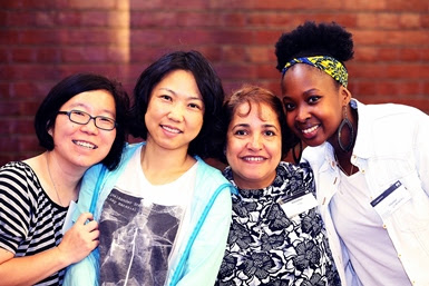 Four women smiling at the camera.