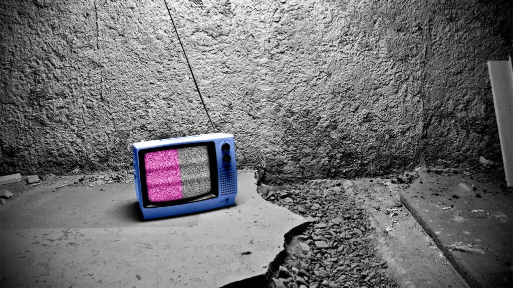 A TV showing pink and white static, which is a type of white noise.